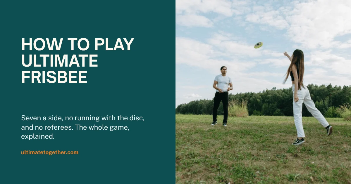 Two people playing ultimate frisbee together on a grass field