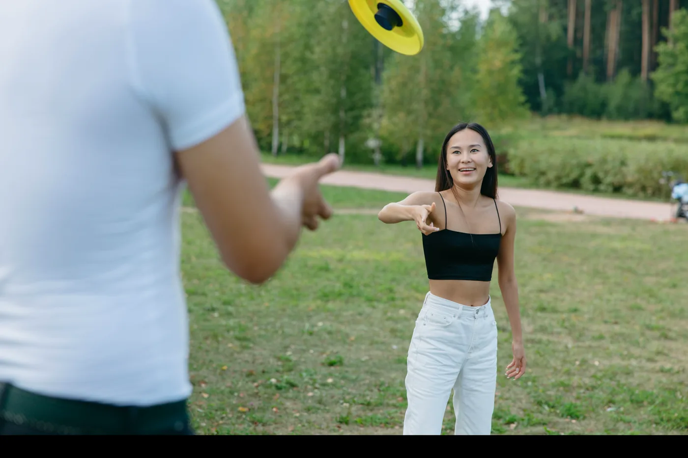 A beginner learning to throw a flying disc in a sunny park